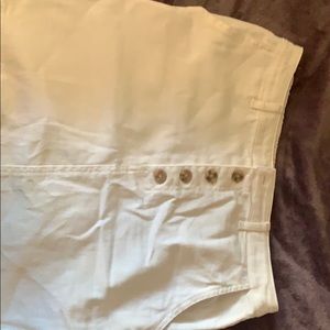 Creme color shirt with 5 brown buttons